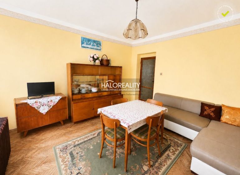 Living room in a family house with carpet and furniture, floor with wood decor.