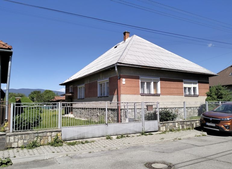A family house on Štúrova Street in Sučany, with a large yard and a car in front.