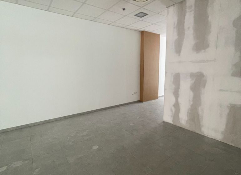 Offices with white walls and tile-patterned flooring.