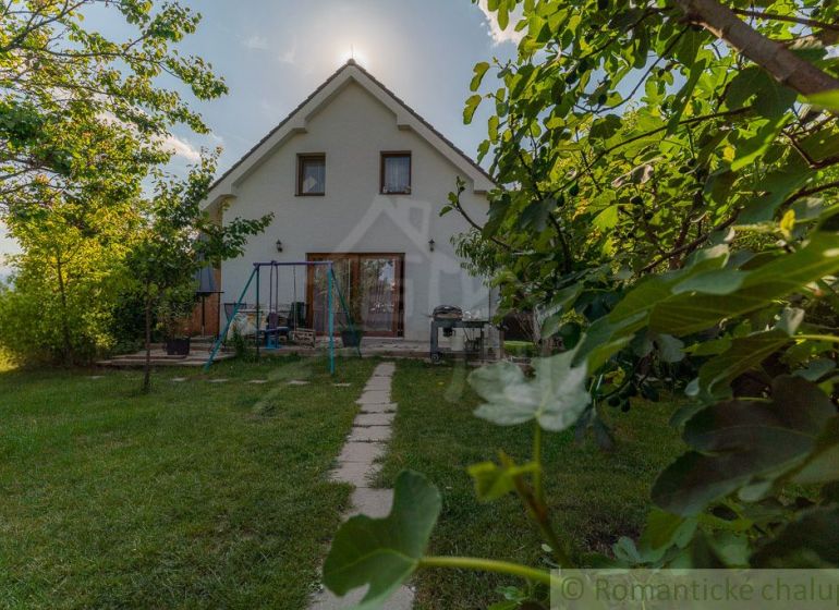 A family house in Bernolákovo with a large garden and a pathway amidst greenery.