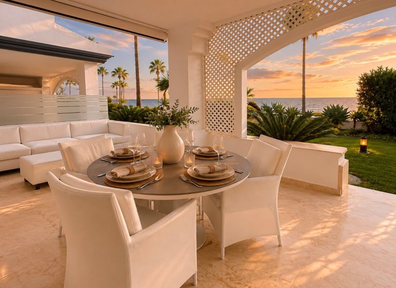 Terrace of a 4-bedroom apartment with an ocean view, comfortable seating, and elegant dining.