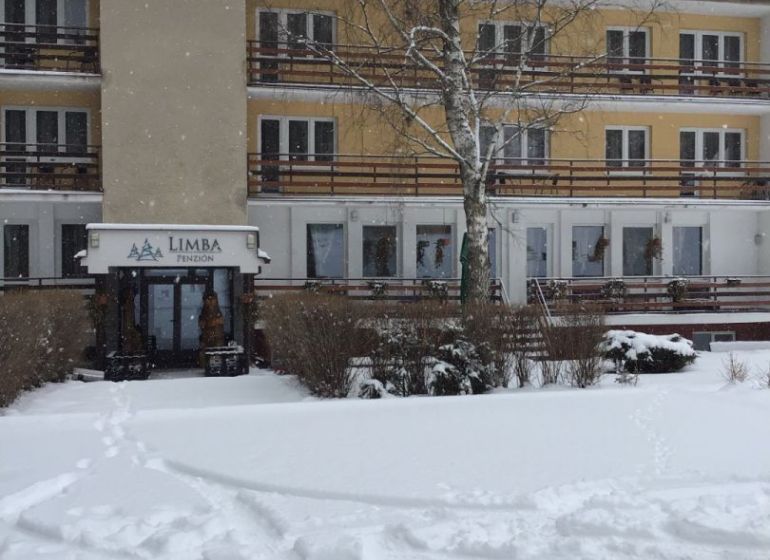 Hotel and guesthouse in Liptovský Ján with a snow-covered roof and exterior.