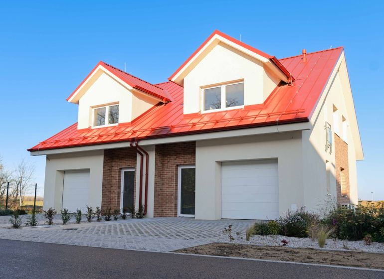 A family house in Andovce with a red roof and brick cladding.
