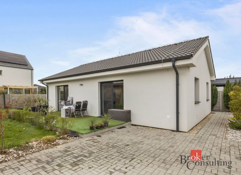 A family house in Bratislava-Podunajské Biskupice with a terrace, garden, and paved walkway.