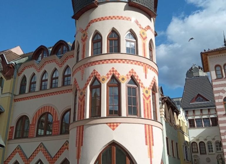 A historic building with rounded towers at the Courtyard of Europe in Komárno, commercial spaces.