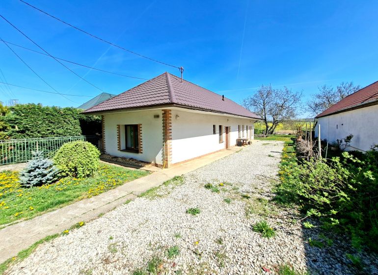 A family house in the town of Tehla on Tehla Street with a landscaped garden and a gravel path.