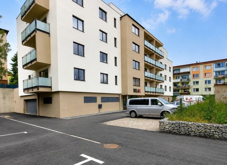 An apartment building on Letná Street in Stará Ľubovňa with parking spaces in front of the building.