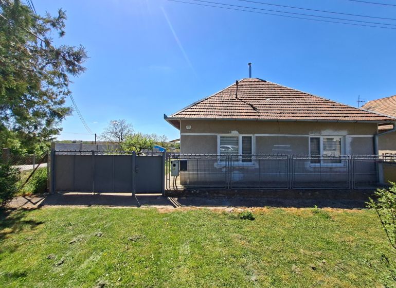 A family house on Jasová Street in Jasová with a grassy garden and fencing.