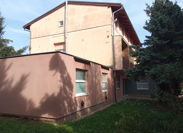 A building among trees in Patince, suitable for hotels and guesthouses.