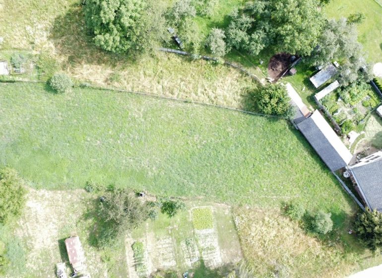 Aerial view of residential plots in Vlachovo with grassy area and garden.