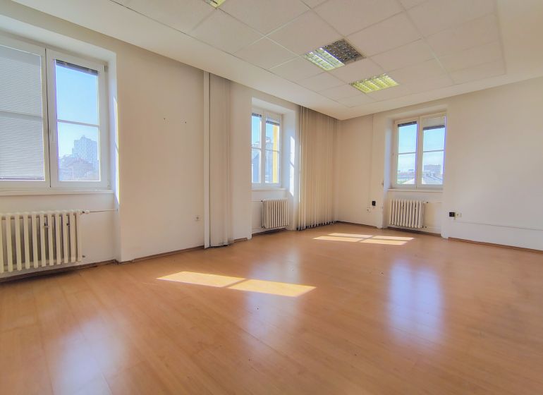 Empty office with wood-patterned flooring and large windows, Bratislava - Staré Mesto.