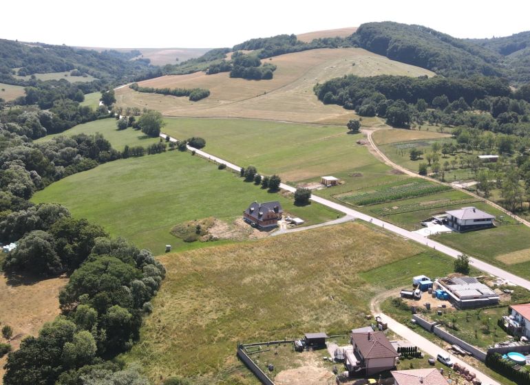 Land with residential plots near Laski Street in Vrbovce, green fields and houses.