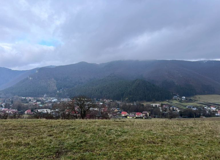 Panorama of agricultural and forest lands in Stránske with a view of the mountains and the village.