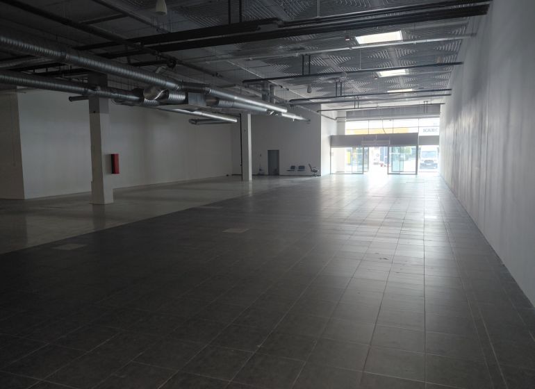 Spacious commercial spaces with large windows and high ceilings.