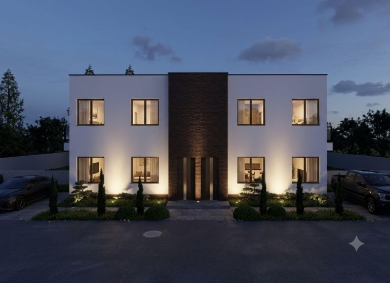 Illuminated facade of a two-story house with a symmetrical design in the village of Veľká Mača.