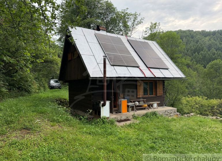 A family house in Kokava nad Rimavicou surrounded by nature, with solar panels on the roof.