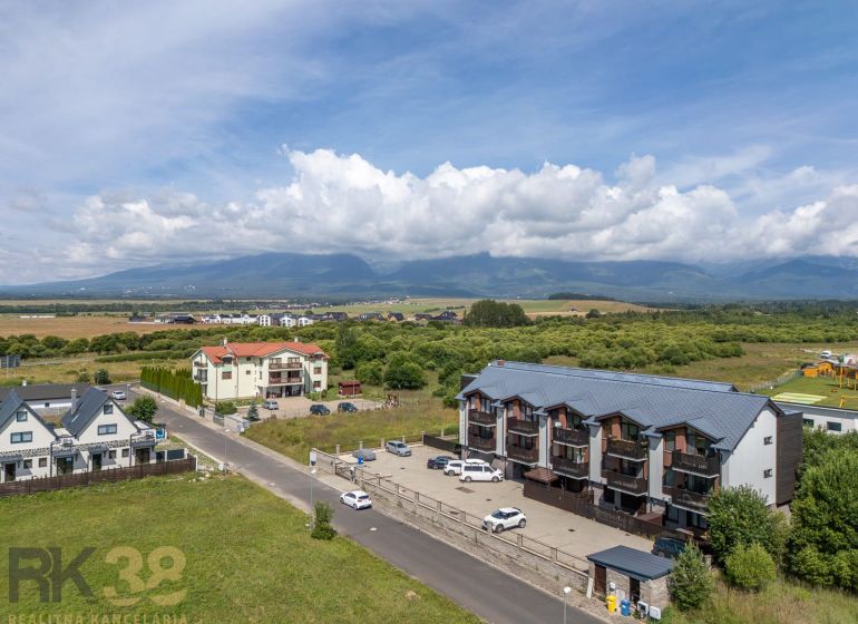View of Futbalová Street in Veľká Lomnica, surrounded by nature and rural landscape.