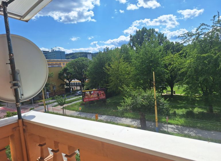View of greenery and 17. novembra Street in Prešov from a 2-room apartment.