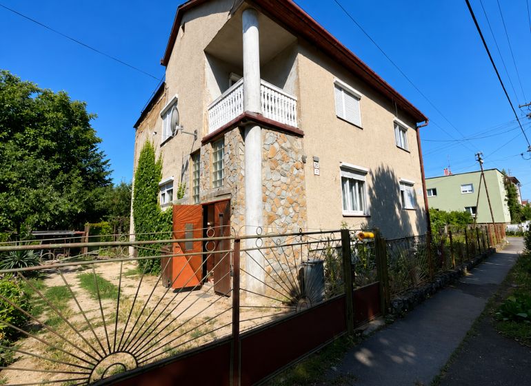 A family house on Mládežnícka Street in Šahy with stone cladding and a garden.