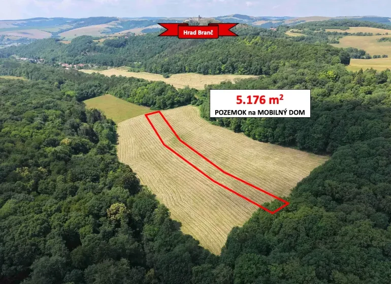 The landscape in Podbranč with extensive gardens, bordered by a forest, with a marked plot.