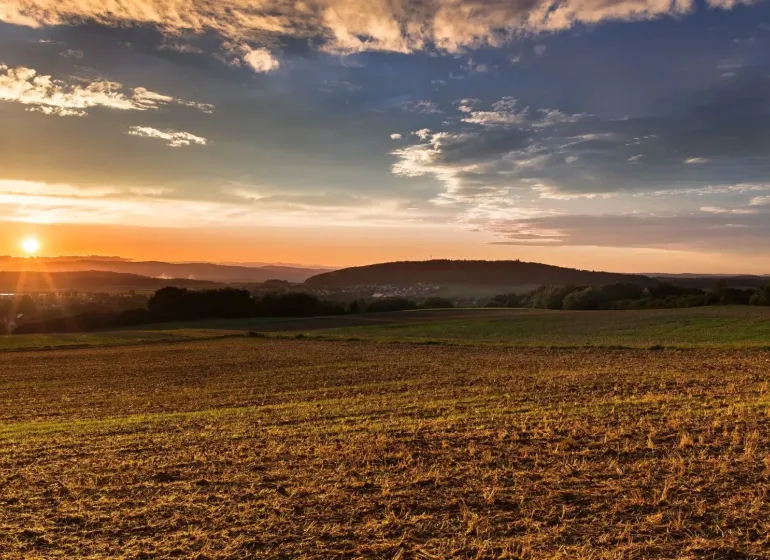 Sunset over the agricultural and forest lands in Boťany creates a picturesque landscape.