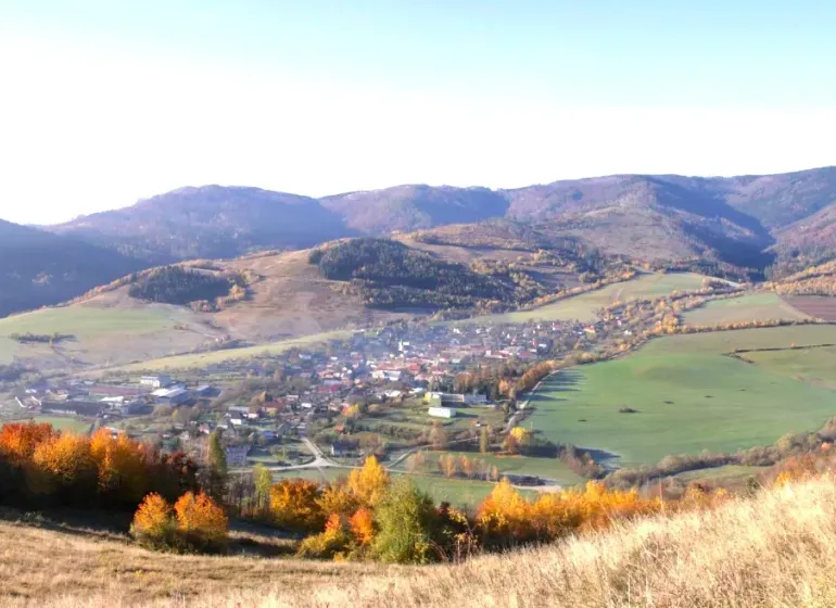 A view of agricultural and forest lands around Rejdová, surrounded by autumn landscape.