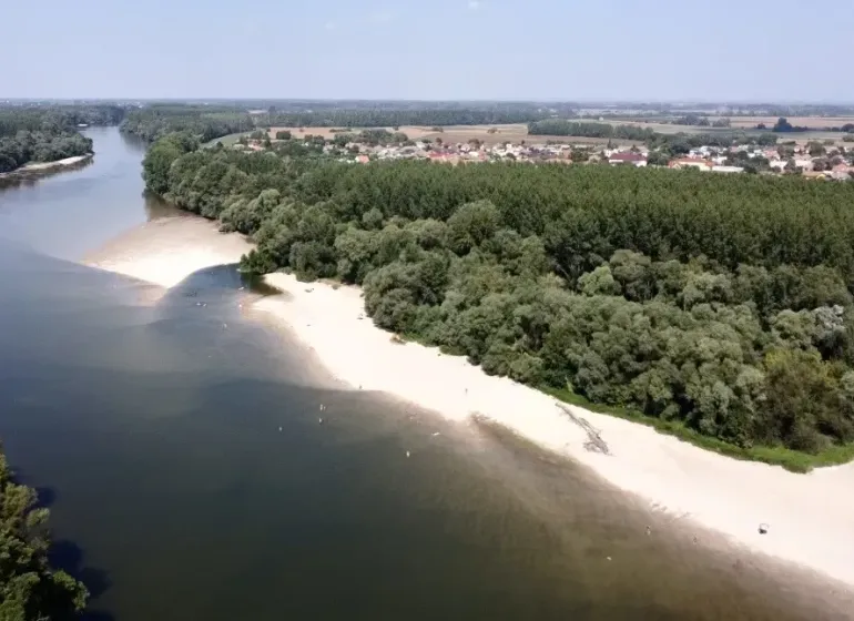 Aerial view of agricultural and forest land near the river in Zemné.