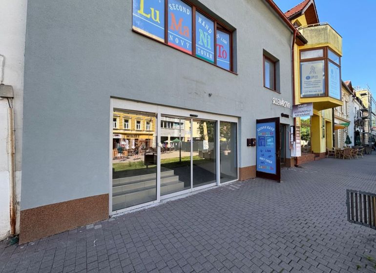 Commercial premises on St. Egidius Square, Poprad, with a glass facade and paving in front of the entrance.