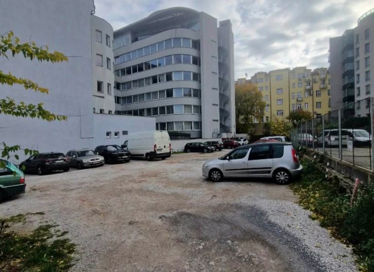 Parking lot with cars between buildings on Stefanicova Street in Bratislava, Old Town.