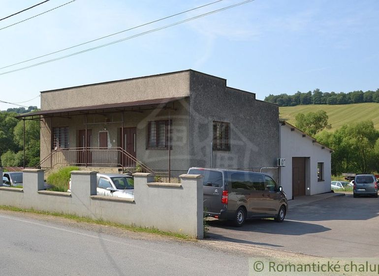 A family house in Varadka with a concrete fence and landscaped surroundings.