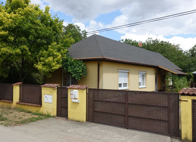A family house in Mojmírovce on Tretí rad street, with a subtly coordinated fence and greenery.