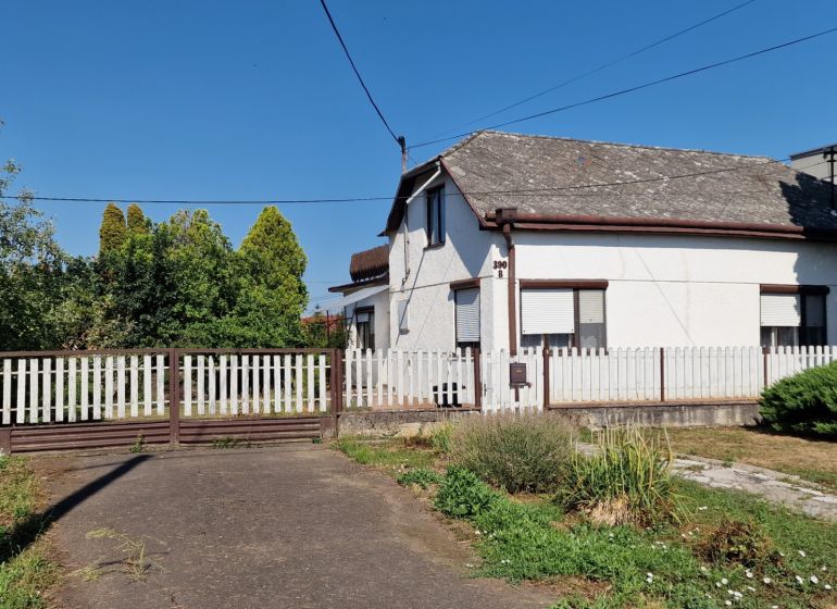 A family house on 29th August Street in Trebišov with a white wooden fence and a garden.