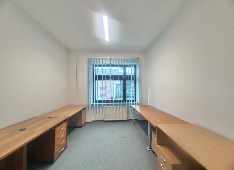 Offices with wood-patterned flooring, work desks, and blinds.