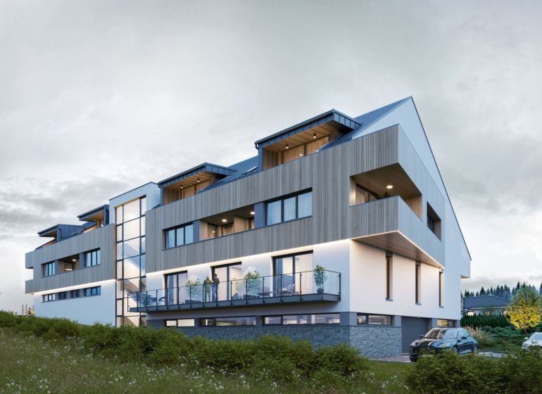 Modern architecture of the apartment complex in Mlynica with balconies and green surroundings.