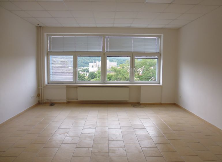 Spacious offices with tiled floors and large windows with a view.