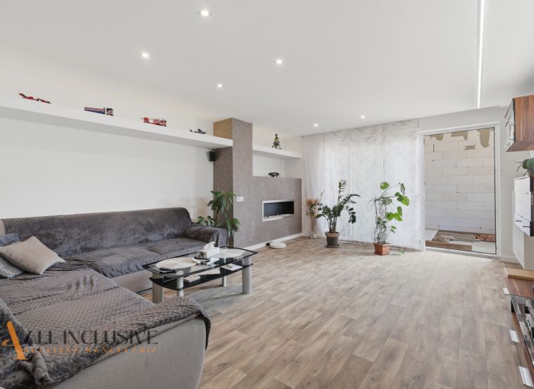 Living room in a family house with comfortable seating and a wooden decor floor.