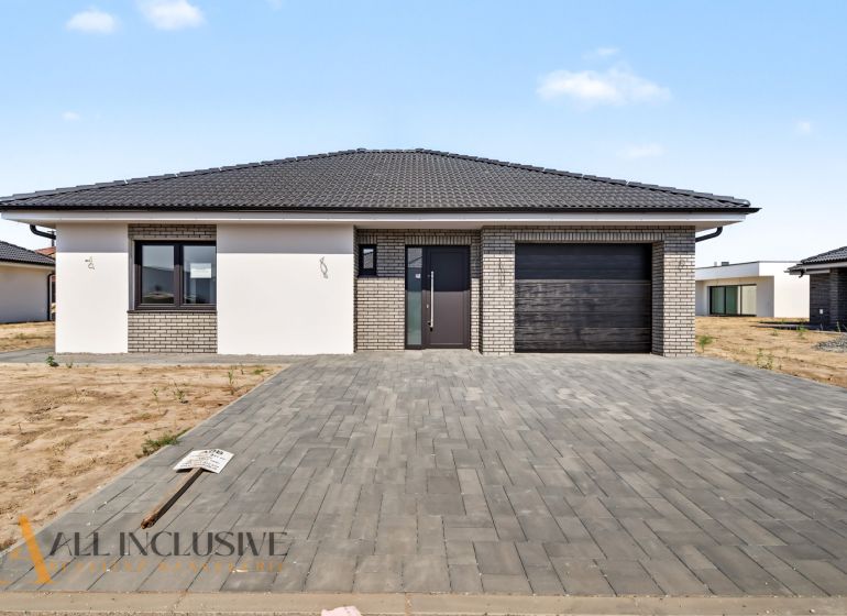 A family house in Hviezdoslavov with a brick facade and a spacious paved driveway.