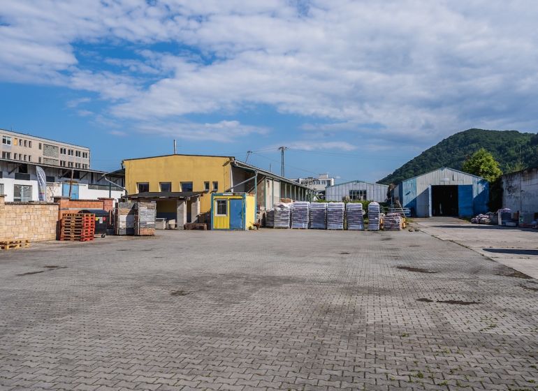 The area on Zvolenská Road in Banská Bystrica with buildings and storage facilities.
