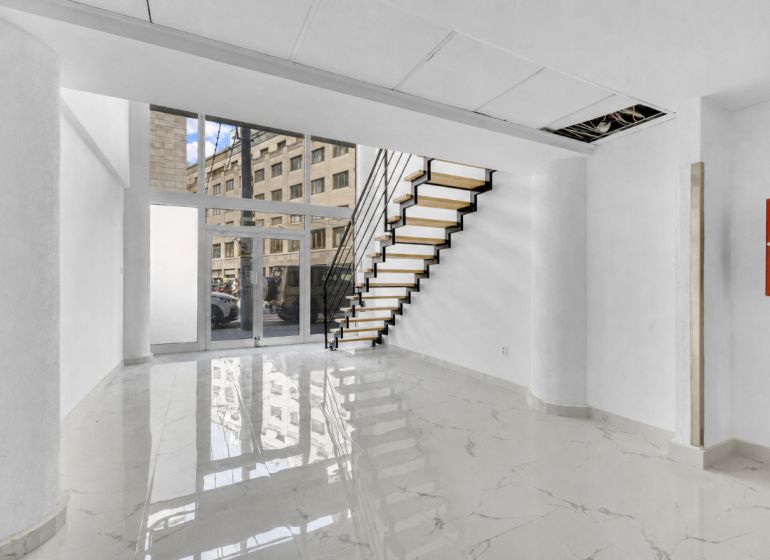 Commercial premises with a marble floor and staircase, creating an elegant appearance in the interior.