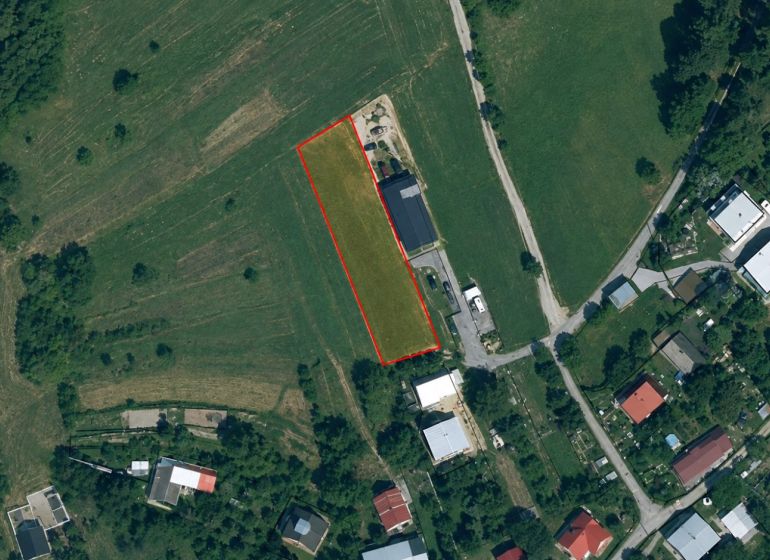Aerial photograph of agricultural and forest lands in Oščadnica with marked outline.