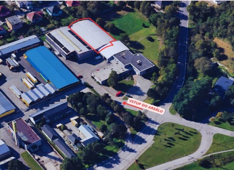 Aerial view of warehouses and halls in Žilina surrounded by greenery and buildings.