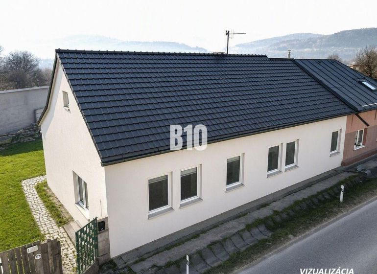 The family house in Bytča has a sloped roof and white facades.