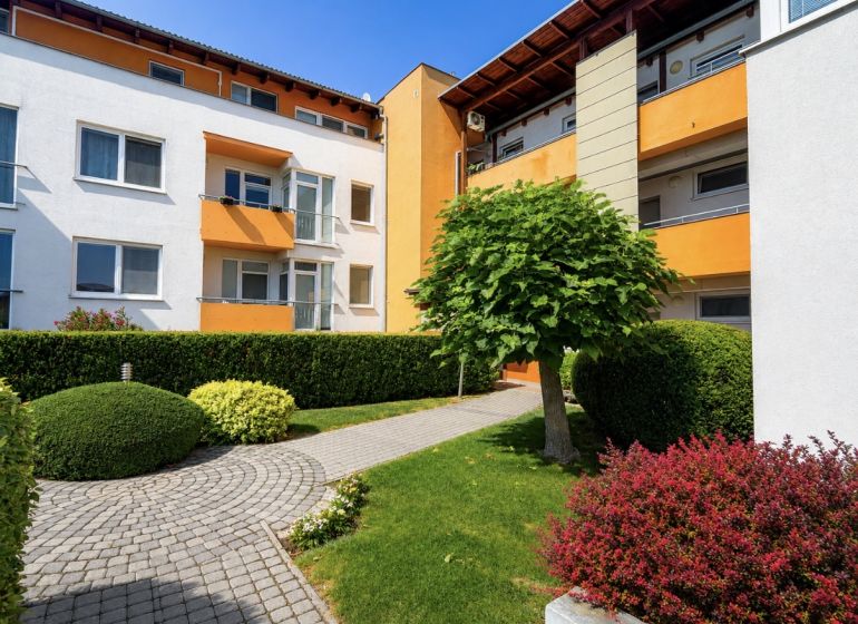 Apartment building on Čerešňová Street in Chorvátsky Grob surrounded by landscaped greenery.