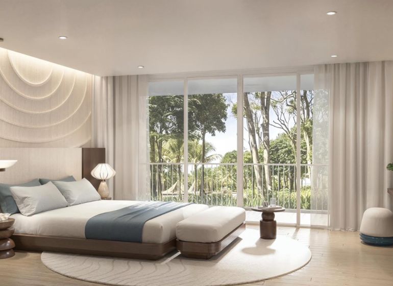 Bright bedroom in a 2-room apartment with large windows and a wooden decor floor.