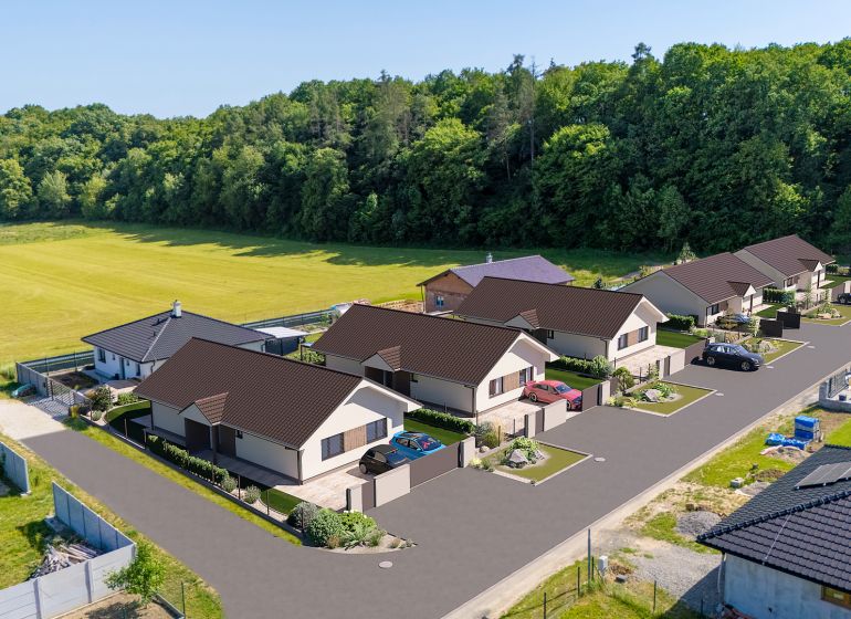 Family houses on Tuchyňa Street in the village of Tuchyňa, surrounded by forest and fields.