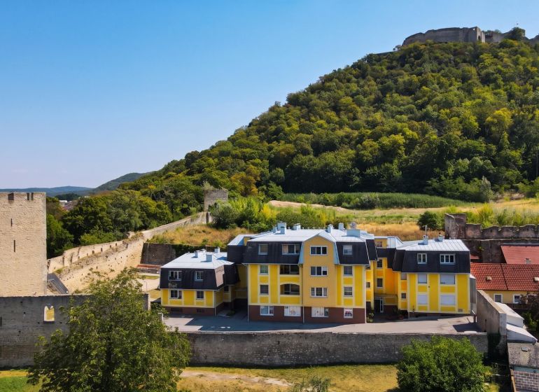 Yellow buildings on Babenbergerstraße in Hainburg an der Donau with historic fortifications.