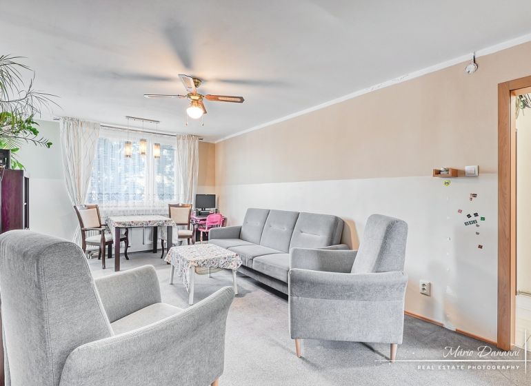 A bright living room in a 4-room apartment with comfortable furniture and decorative details.