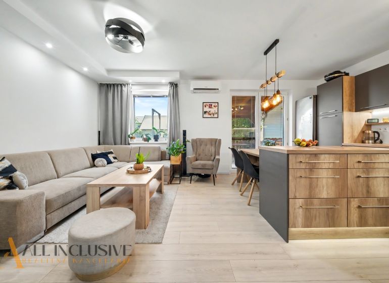 Living room with a kitchenette in a 3-room apartment, floor with wooden decor.