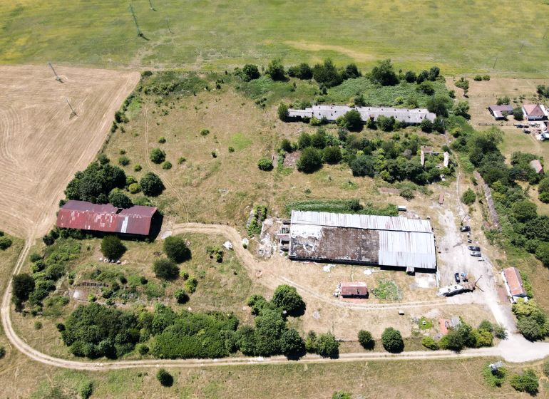Fields and abandoned buildings surrounded by greenery in Stará Turá. Unusual properties.