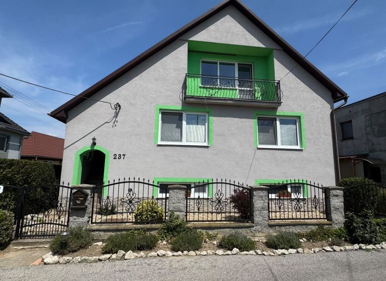A family house on Tešmak Street in Šahy with green shutters and a balcony.
